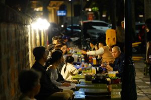 People are enjoying a meal outdoors at night