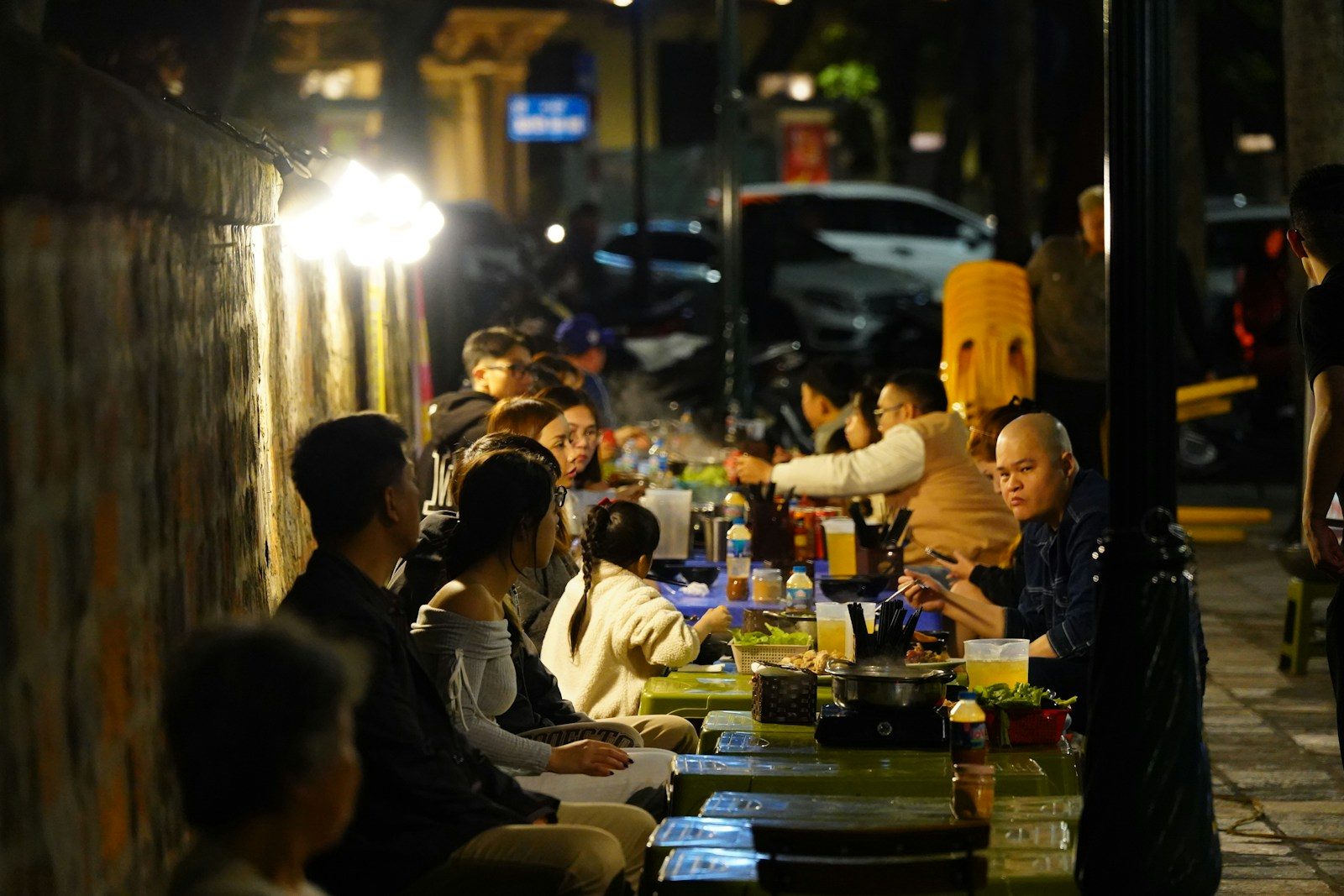 People are enjoying a meal outdoors at night